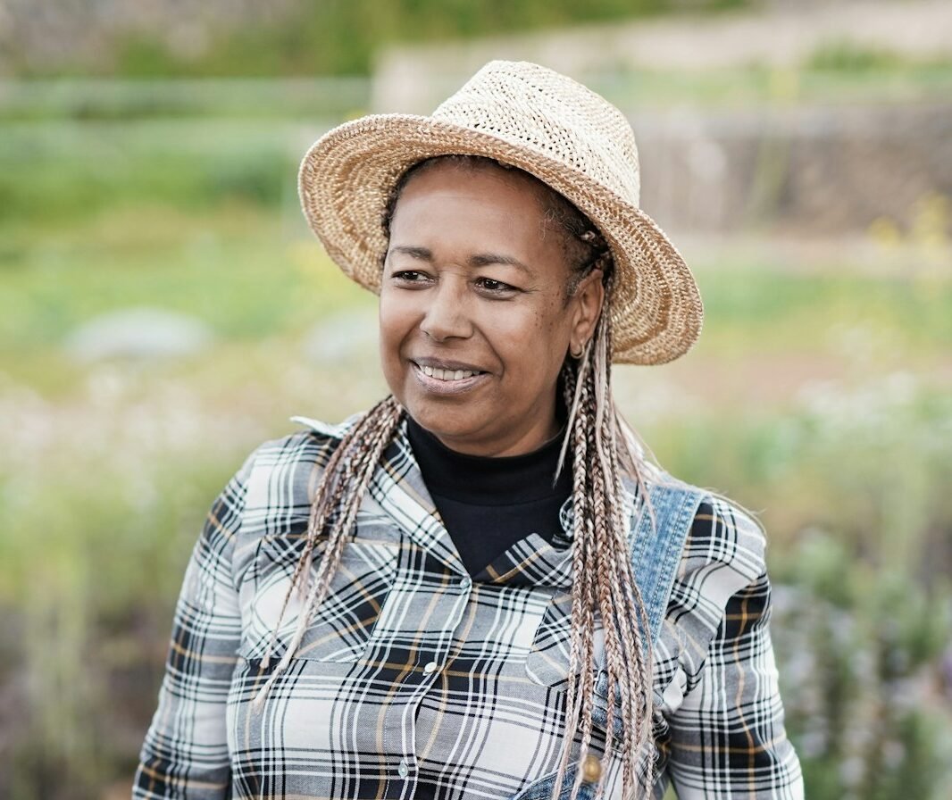 African senior woman gardening - Happy black person enjoy the harvest period at farm