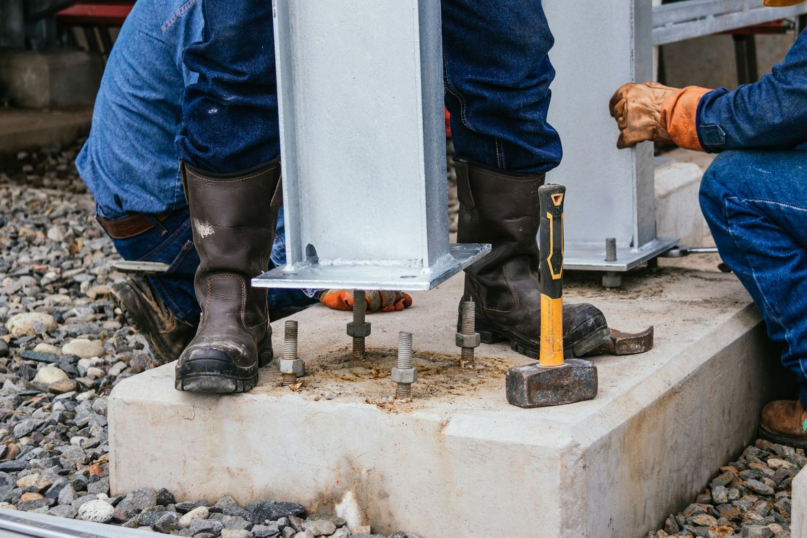 Shot of men working on a pillar foundation - industrial concept